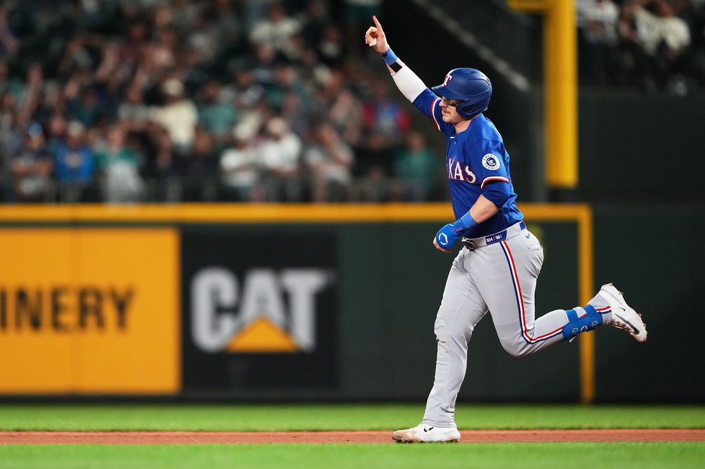 Texas Rangers' Danny Jansen jogs the bases after hitting a three-run home run against the Seattle Mariners during the fifth inning of a baseball game, Tuesday, Sept. 8, 2026, in Seattle. (AP Photo/Lindsey Wasson)
