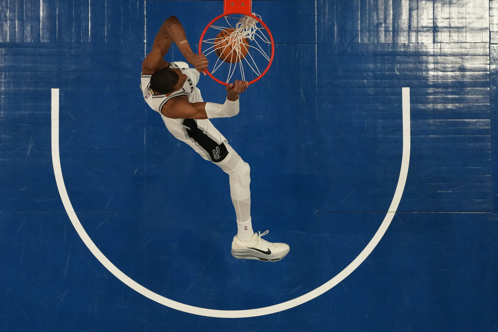 San Antonio Spurs forward Victor Wembanyama (1) dunks during the first half of Game 3 of a NBA basketball second-round playoff series against the Minnesota Timberwolves, Friday, May 8, 2026, in Minneapolis. (AP Photo/Abbie Parr)