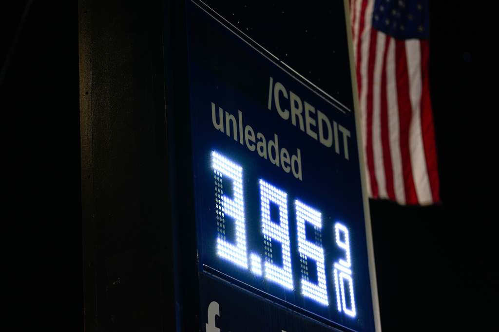 An American flag flies outside a gas station as gasoline prices are displayed on Sunday, March 8, 2026, in Portland, Ore. (AP Photo/Jenny Kane)