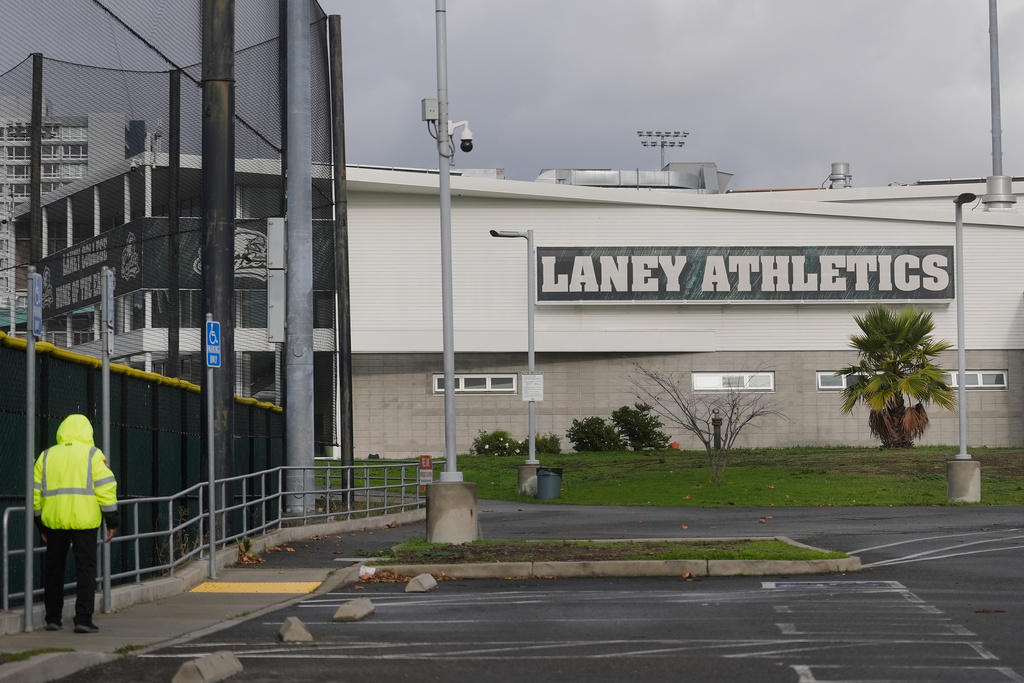 A guard patrols outside of athletics facilities at Laney College, in Oakland, Calif., Monday, Nov. 17, 2025. (AP Photo/Jeff Chiu)