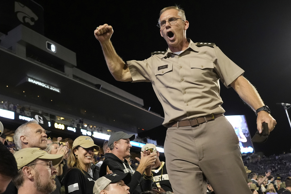 Westpoint commandant Lieutenant General Steven W. Gilland cheers after Army beat Kansas State in an NCAA college football game Saturday, Sept. 6, 2025, in Manhattan, Kan. (AP Photo/Charlie Riedel)