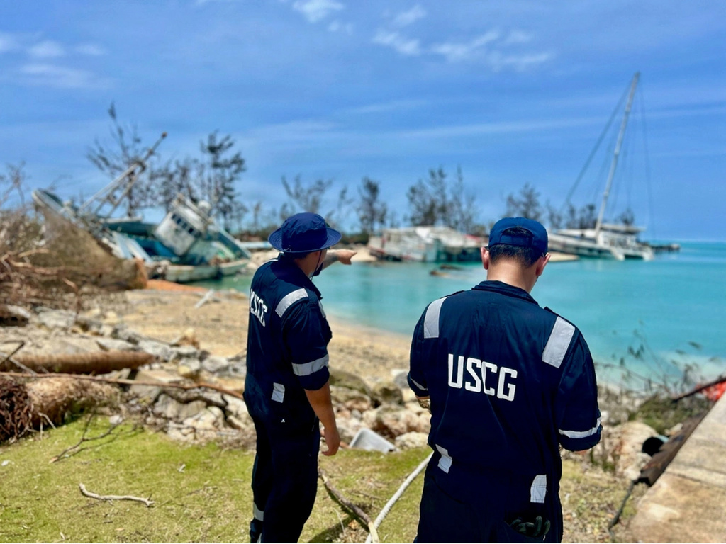 This photo provided by the U.S. Coast Guard , U.S. Coast Guard responders assess Smiling Cove in Saipan on April 18, 2026. (Lt. Whip Blacklaw/U.S. Coast Guard via AP)