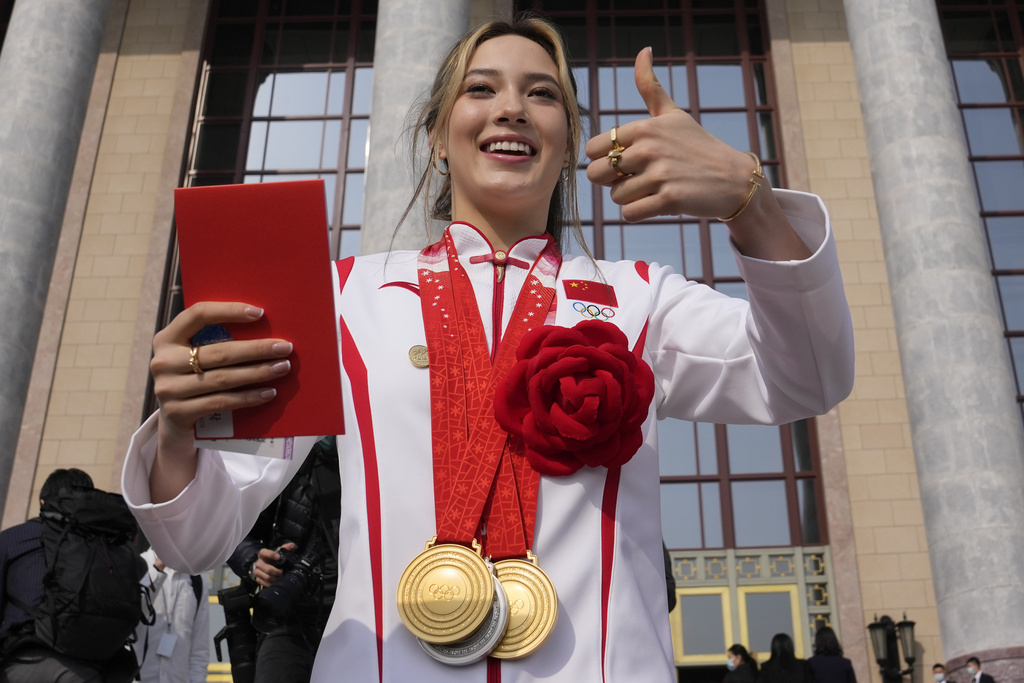 FILE - Olympic gold medalist Eileen Gu poses with her three medals before a commendation ceremony for role models of the Beijing Winter Olympics and Paralympics at the Great Hall of the People, on April 8, 2022, in Beijing. (AP Photo/Ng Han Guan, File)