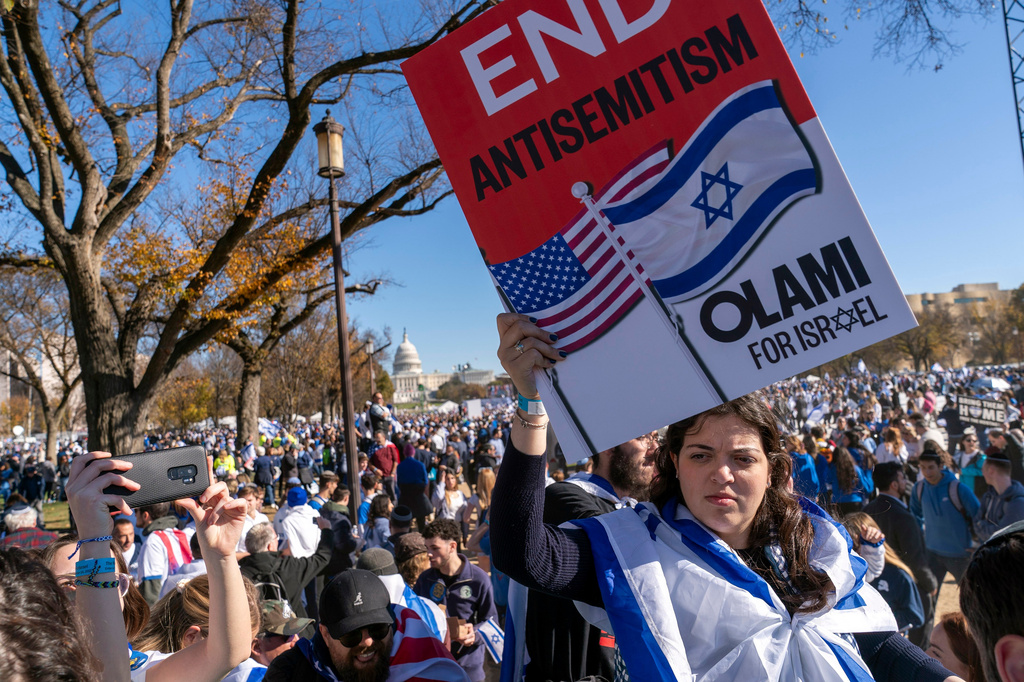 FILE - A woman holds a sign saying, "end antisemitism" while attending a March for Israel rally Nov. 14, 2023, on the National Mall in Washington. (AP Photo/Jacquelyn Martin, File)