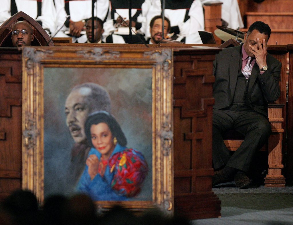 FILE - Rev. Jesse Jackson, right, reacts during a prayer service for Coretta Scott King at the new Ebenezer Church on Auburn Ave. in Atlanta Monday, Feb. 6, 2006. Ebenezer Pastor Rev. Raphael Warnock is at left. (AP Photo/John Bazemore, Pool, File)