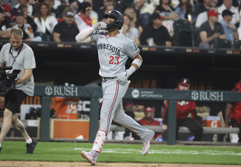 Minnesota Twins Royce Lewis (23) celebrates a three-run home run against the Chicago White Sox during the fourth inning of a baseball game, Friday, Aug. 22, 2025, in Chicago. (AP Photo/Talia Sprague)