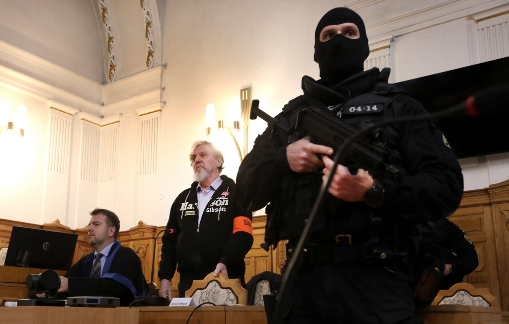 Juraj Cintula, centre, who shot and seriously injured Prime minister of Slovakia Robert Fico last year, attends hearings at the Specialized Criminal Court in Banska Bystrica, Slovakia, Tuesday, Oct. 21, 2025. (Jan Kroslak/TASR via AP)