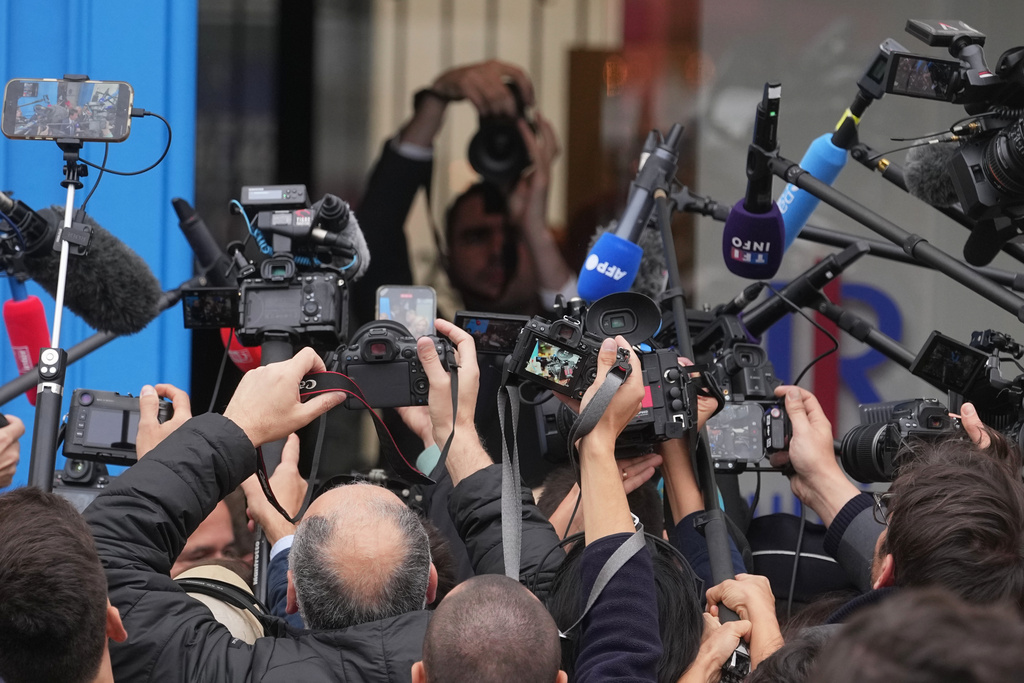 Reporters gather outside the conservative Party Les Republicains headquarters Monday, Oct. 6, 2025 in Paris after France's prime minister Sebastien Lecornu resigned plunging the country into a deep political crisis. (AP Photo/Thibault Camus)