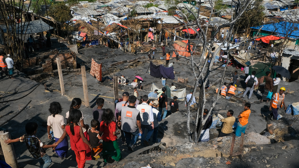 Children walk near the site of a fire that broke out in Camp 16, one of more than 30 Rohingya refugee camps in the Cox's Bazar district, Bangladesh, Tuesday, Jan. 20, 2026. (Jessica Wanless, Norwegian Refugee Council via AP)