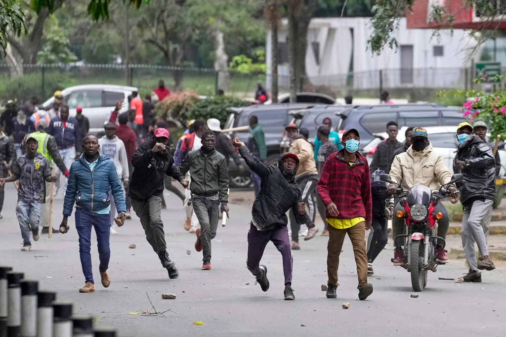 FILE - Pro-government supporters throw stones towards protesters during a demonstration over the death of blogger Albert Ojwang in police custody, in downtown Nairobi, Kenya, Tuesday, June 17, 2025. (AP Photo/Brian Inganga, File)