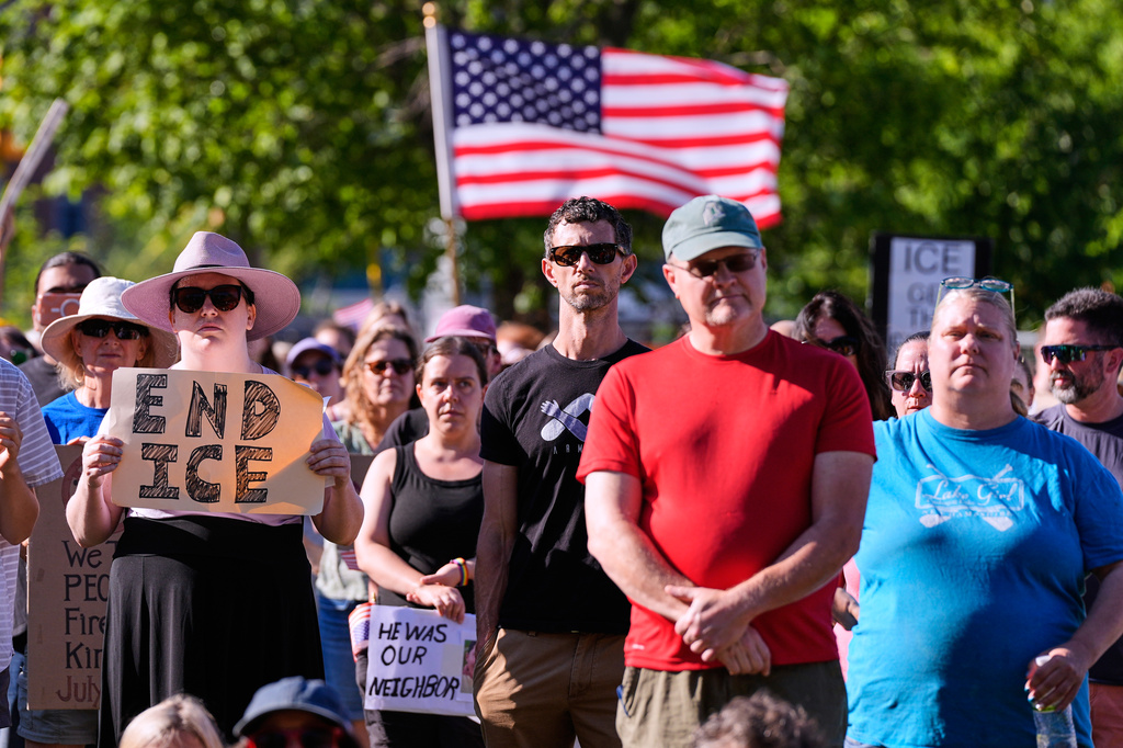 People hold signs in protest during a vigil for Johan Sebastian Duran Guerrero, a Colombian national who was shot and killed by an ICE agent, Friday, July 17, 2026, in Biddeford, Maine. (AP Photo/Charles Krupa)