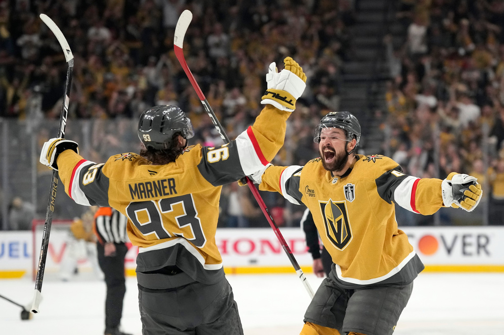 Vegas Golden Knights right wing Mitch Marner, left, celebrates his third goal for a hat trick with center Tomas Hertl during the second period in Game 3 of the NHL hockey Stanley Cup Final series against the Carolina Hurricanes, Saturday, June 6, 2026, in Las Vegas. (AP Photo/John Locher)