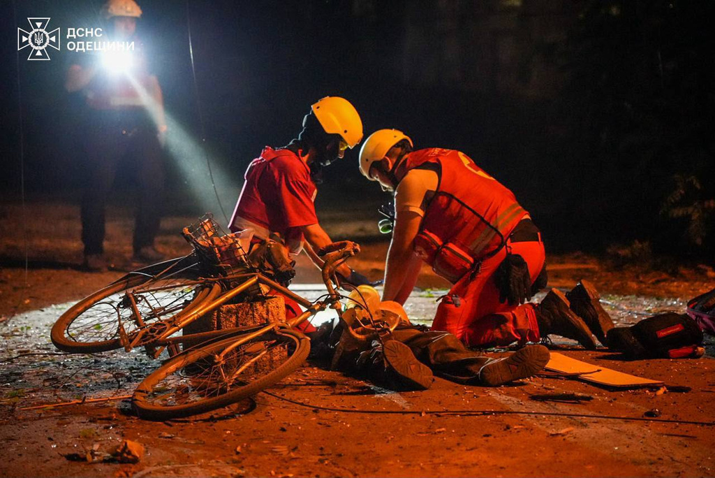 In this photo provided by the Ukrainian Emergency Service, paramedics give first aid to an injured resident following a Russian missile attack in center of Odesa, Ukraine, Friday, July 17, 2026. (Ukrainian Emergency Service via AP)
