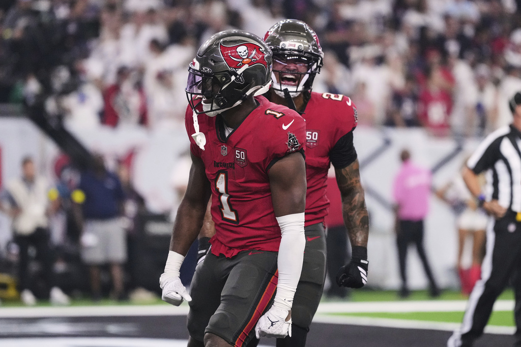 Tampa Bay Buccaneers running back Rachaad White (1) and Emeka Egbuka (2) celebrate a touchdown run by White in the second half of an NFL football game against the Houston Texans Monday, Sept. 15, 2025, in Houston, Texas. (AP Photo/Eric Gay)