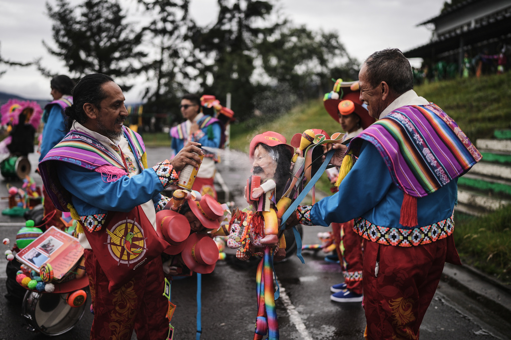 Revelers get their costumes and props ready for the start of the Black and White Carnival, recognized by UNESCO as Intangible Cultural Heritage, in Pasto, Colombia, Tuesday, Jan. 6, 2026. (AP Photo/Ivan Valencia)