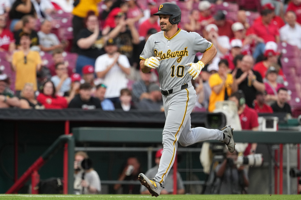 Pittsburgh Pirates' Bryan Reynolds celebrates a solo home run while crossing home plate during the second inning of a baseball game against the Cincinnati Reds, Tuesday, March 31, 2026, in Cincinnati. (AP Photo/Kareem Elgazzar)