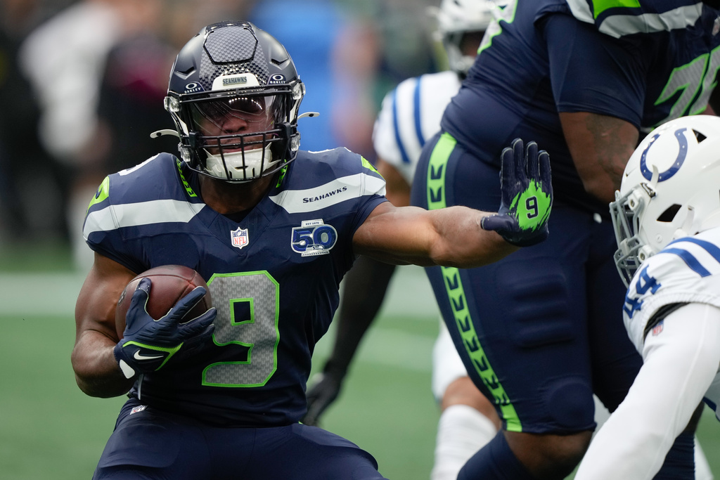 Seattle Seahawks running back Kenneth Walker III (9) holds on to the ball during the first half of an NFL football game against the Indianapolis Colts, Sunday, Dec. 14, 2025, in Seattle. (AP Photo/Stephen Brashear)