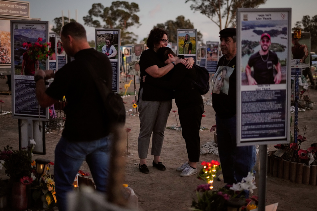 People visit the site of the Nova music festival, where hundreds of revelers were killed and abducted by Hamas and taken into Gaza, as Israel marks the second year anniversary of the attack, near Kibbutz Reim, southern Israel, Tuesday, Oct. 7, 2025. (AP Photo/Ariel Schalit)