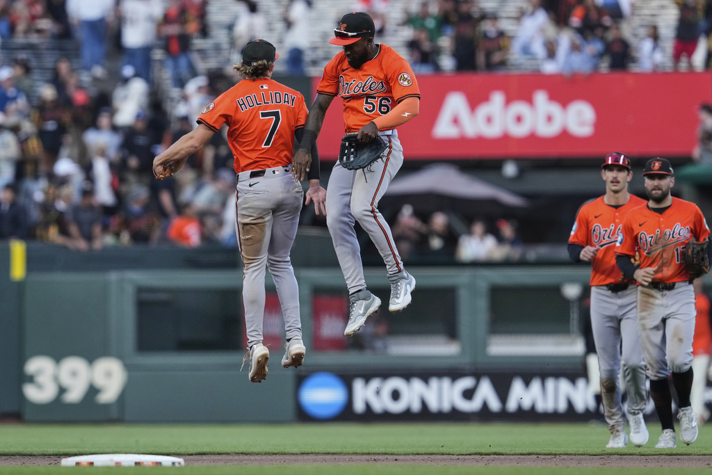 Baltimore Orioles second baseman Jackson Holliday (7) and left fielder Daniel Johnson (56) celebrate after the team's victory over the San Francisco Giants in a baseball game Saturday, Aug. 30, 2025, in San Francisco. (AP Photo/Godofredo A. Vásquez)