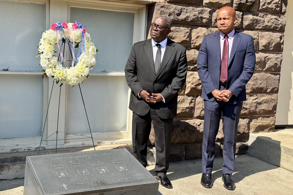 This photo taken with a smartphone shows Rev. Arthur Price, Jr., left, and Bryan Stevenson, the founder and executive director of the Equal Justice Initiative, attending a commemoration service in honor of the 63rd anniversary of the church's bombing at 16th Street Baptist Church in Birmingham, Ala., Tuesday, Sept. 15, 2026. (AP Photo/Kim Chandler)