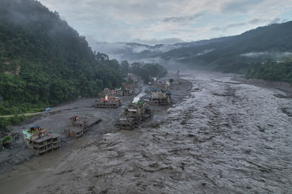 FILE - Homes sit damaged in the aftermath of flash flooding along the Trishuli River in the Trishuli Bazaar area of Nuwakot district, Nepal, Aug. 30, 2026. (AP Photo/Rajesh Kumar Singh, File)
