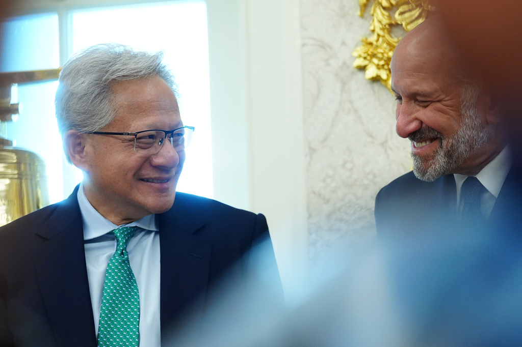 NVIDIA CEO Jensen Huang talks with Commerce Secretary Howard Lutnick as President Donald Trump speaks in the Oval Office of the White House about Dulles International Airport modernization, Wednesday, July 29, 2026, in Washington. (AP Photo/Julia Demaree Nikhinson)