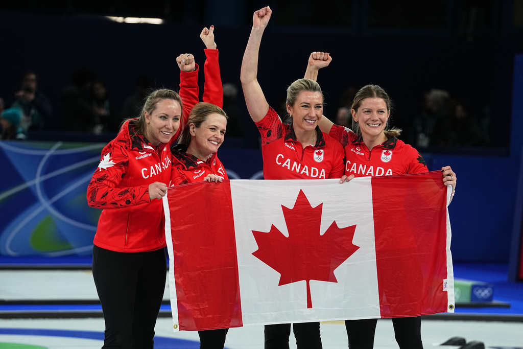 Canada's Rachel Homan, Tracy Fleury, Sarah Wilkes and Emma Miskew celebrate winning their women's curling bronze medal match against the United States, at the 2026 Winter Olympics, in Cortina d'Ampezzo, Italy, Saturday, Feb. 21, 2026. (AP Photo/Fatima Shbair)