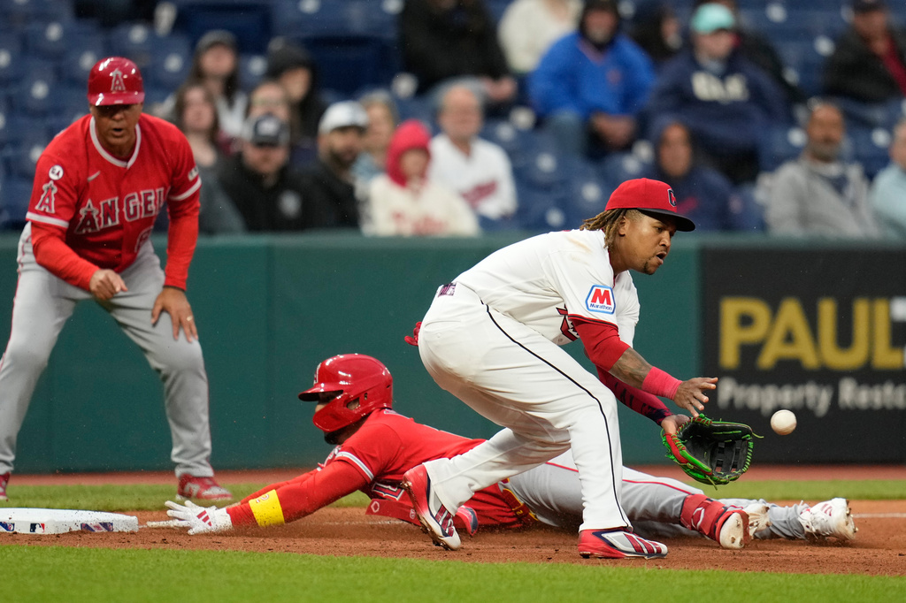 Los Angeles Angels' Oswald Peraza, center, slides safely into third base with a triple as Cleveland Guardians third baseman José Ramírez, right, takes the throw in the sixth inning of a baseball game in Cleveland, Tuesday, May 12, 2026. (AP Photo/Sue Ogrocki)