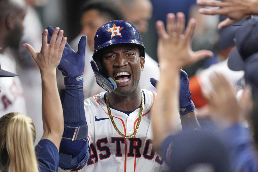 Houston Astros' Jesús Sánchez celebrates in the dugout after hitting a home run against the Colorado Rockies during the second inning of a baseball game Tuesday, Aug. 26, 2025, in Houston. (AP Photo/David J. Phillip)