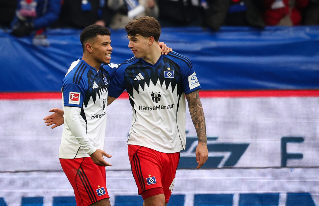 Hamburger's Ransford Königsdörffer, left, celebrates with Luka Vuskovic after scoring their side's first goal during the German Bundesliga soccer match between Hamburger SV and 1. FC Union Berlin, in Hamburg, Germany, Saturday, Dec. 14, 2026. (Christian Charisius/dpa via AP)