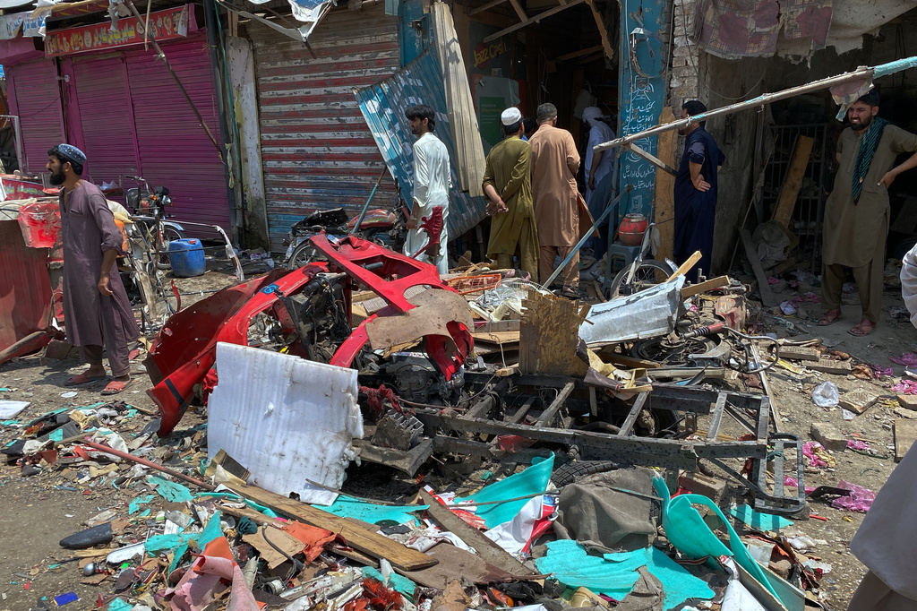 Local residents examine damage at the site of a bomb explosion at a market in Sarai Norag in Lakki Marwat, a district in Pakistan's Khyber Pakhtunkhwa province, Tuesday, May 12, 2026. (AP Photo/Farhat Ullah)