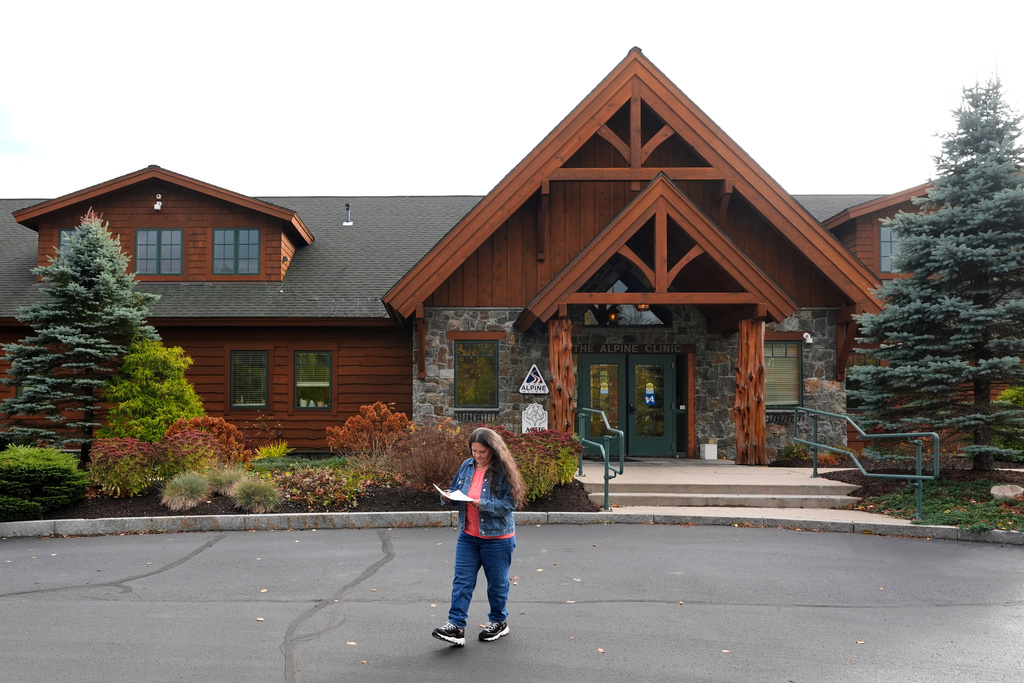 Susan Bushby looks at her medical paperwork after an appointment at Ammonoosuc Community Health Services, Tuesday, Oct. 21, 2025, in Franconia, N.H. (AP Photo/Robert F. Bukaty)