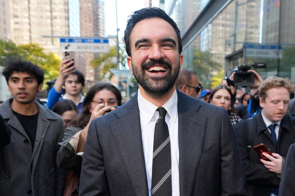 New York City mayoral candidate Zohran Mamdani tries to talk to pedestrians while surrounded by reporters in New York, Monday, Oct. 27, 2025. (AP Photo/Seth Wenig)