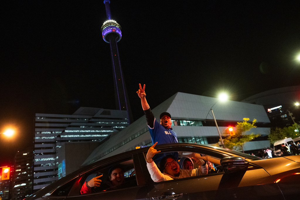 Toronto Blue Jays fans react after the team defeated the Seattle Mariners in Game 7 to take baseball's American League Championship Series in Toronto, Monday, Oct. 20, 2025. (Laura Proctor/The Canadian Press via AP)