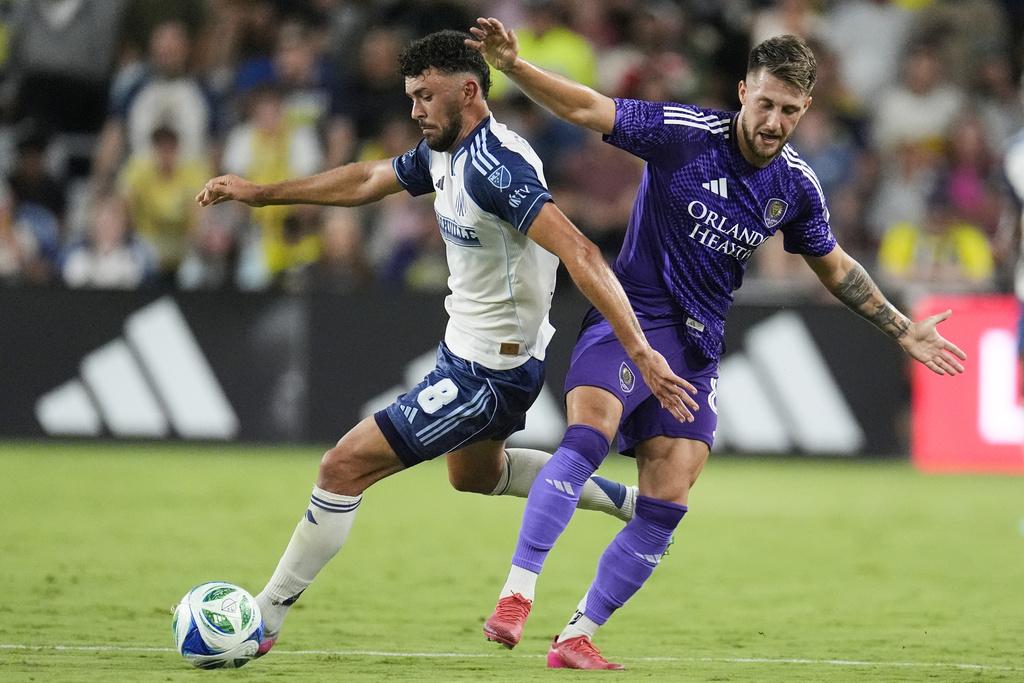 Nashville SC midfielder Patrick Yazbek (8) kicks the ball past Orlando City forward Marco Pašalić, right, during the second half of an MLS soccer match Saturday, Aug. 23, 2025, in Nashville, Tenn. (AP Photo/George Walker IV)