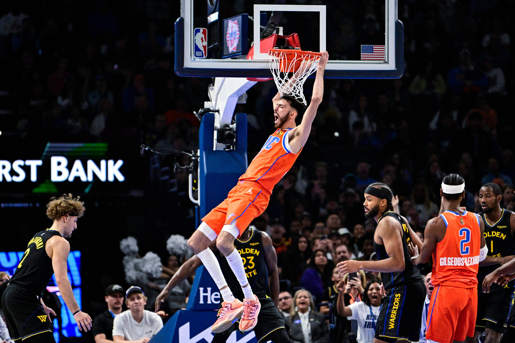 Oklahoma City Thunder center/forward Chet Holmgren (7) celebrates after a dunk against the Golden State Warriors during the first half of an NBA basketball game, Tuesday, Nov. 11, 2025, in Oklahoma City. (AP Photo/Gerald Leong)