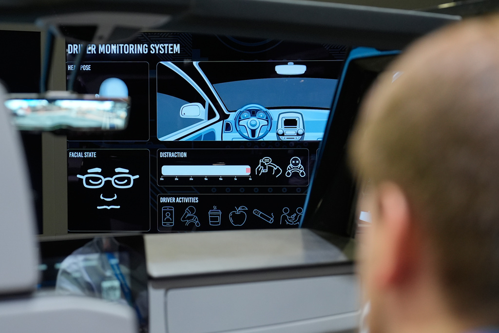People experience a Gentex Corporation driver and in-camera monitoring system exhibit during the CES tech show Tuesday, Jan. 6, 2026, in Las Vegas. (AP Photo/John Locher)