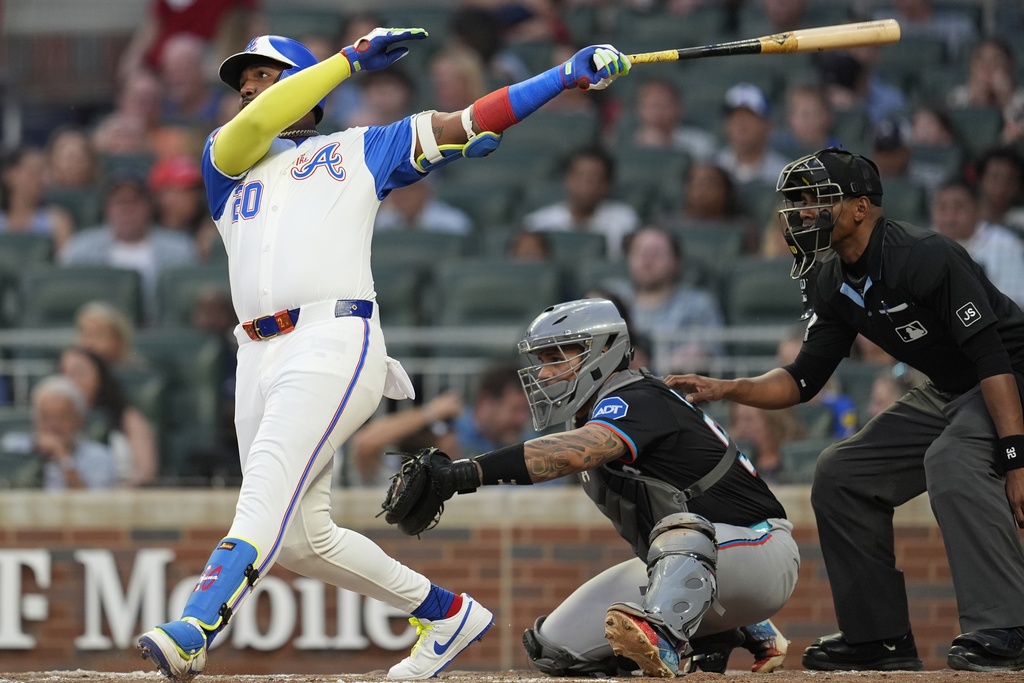 Atlanta Braves designated hitter Marcell Ozuna (20) hits a solo home run against the Miami Marlins in the fourth inning in the second baseball game of a doubleheader, Saturday, Aug. 9, 2025, in Atlanta. (AP Photo/Mike Stewart)