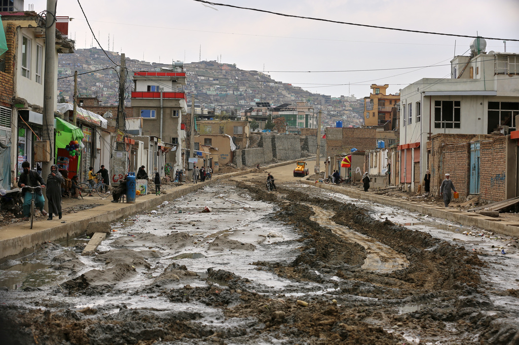 People walk on the sidewalk of a road under construction in Kabul, Afghanistan, Thursday, April 2, 2026. (AP Photo/Siddiqullah Alizai)