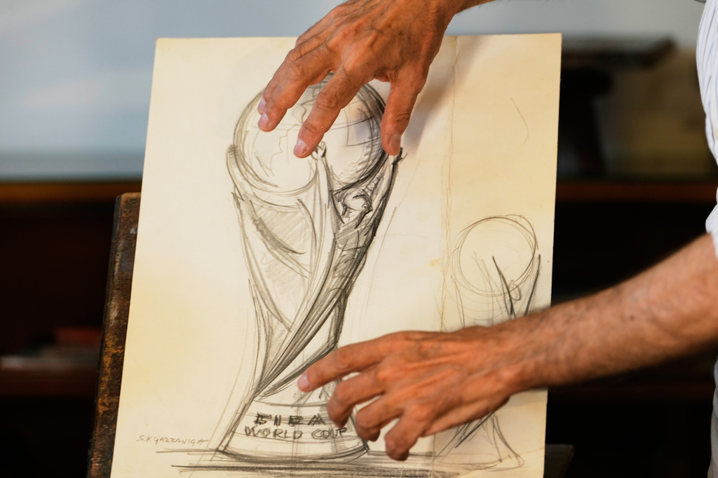 Giorgio Gazzaniga, son of the late sculptor Silvio Gazzaniga, gestures as he speak to the Associated Press explaining the original drawing of World Cup trophy at a warehouse in Pioltello, Saturday, July 11, 2026. (AP Photo/Luca Bruno)