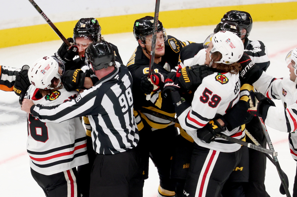 Boston Bruins and Chicago Blackhawks players fight during the third period of an NHL hockey game, Thursday, Oct. 9, 2025, in Boston. (AP Photo/Mark Stockwell)