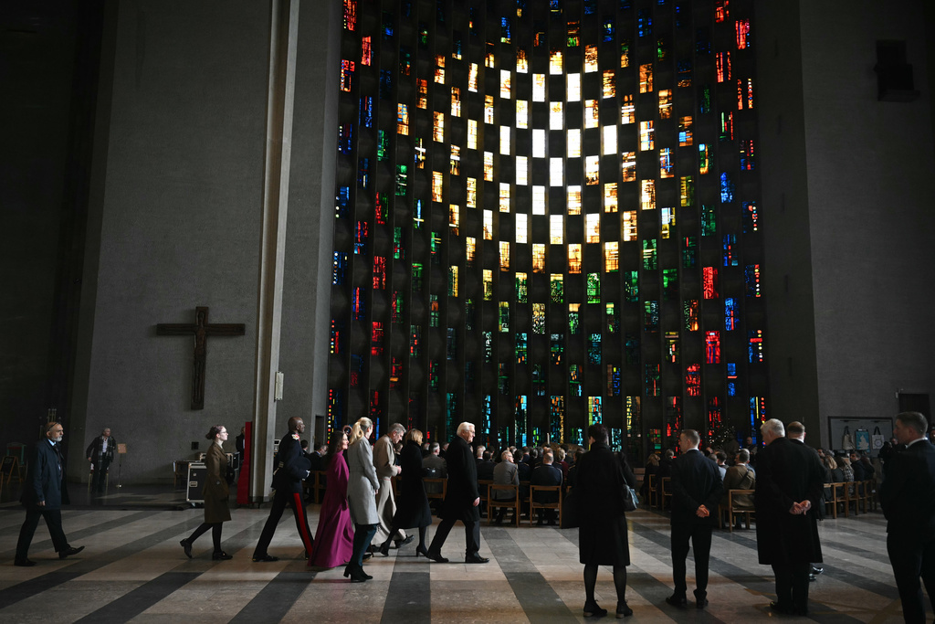 Germany's President Frank-Walter Steinmeier, center, with his wife Elke Budenbender tour the new Coventry Cathedral, in Coventry, England, Friday, Dec. 5, 2025, on the final day of the state visit to the UK. (Oli Scarff/Pool Photo via AP)