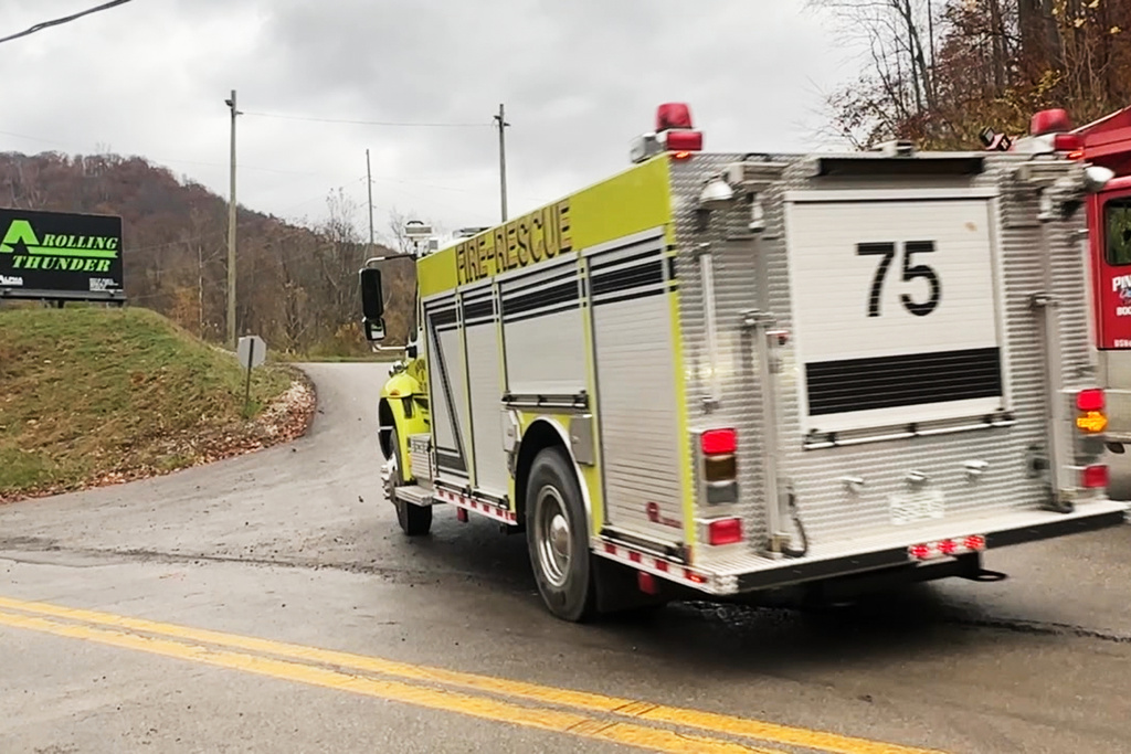 In this image taken from a video provided by WCHS, an emergency vehicle drives past a sign for the Rolling Thunder mine near Drennen, W.Va., Sunday, Nov. 9, 2025. (WCHS via AP)