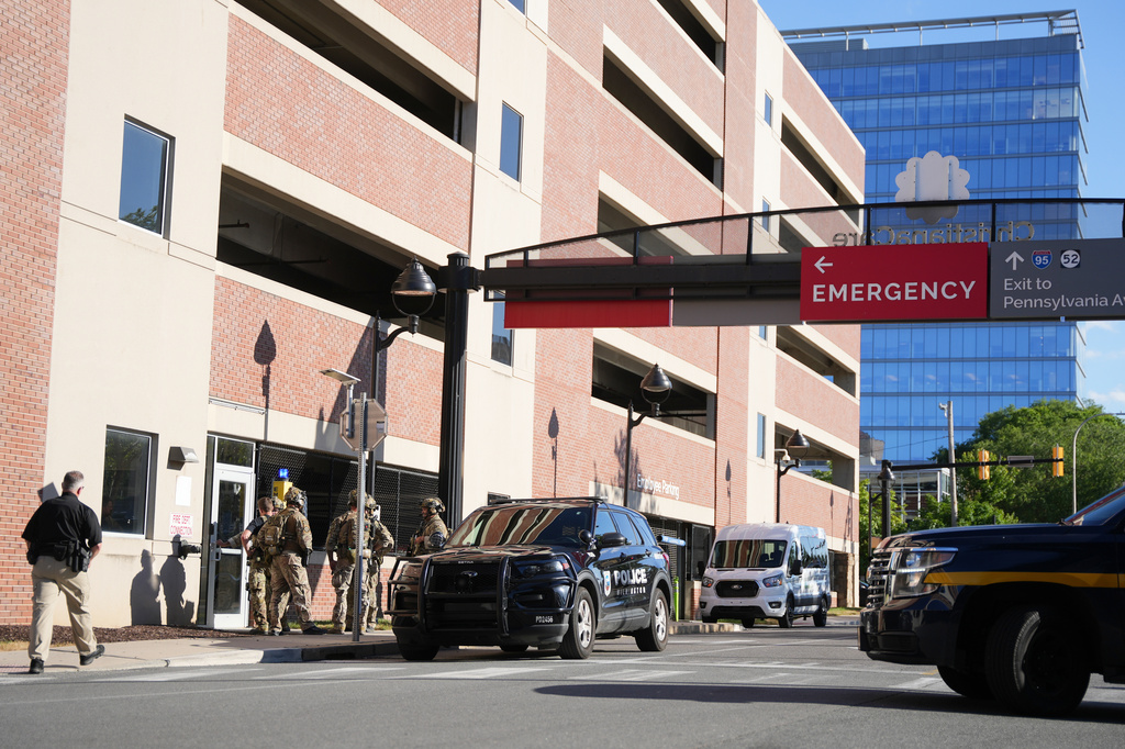 Law enforcement personnel stage outside of Wilmington Hospital in the aftermath of a shooting on Tuesday, June 16, 2026, in Wilmington, Del. (AP Photo/Mingson Lau)