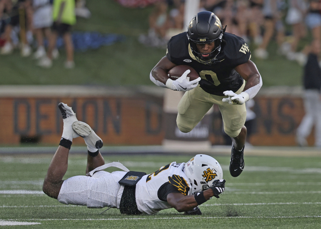 Kennesaw State defensive back Kody Jones trips up Wake Forest running back Ty Clark III in the first half of an NCAA football game on Friday, Aug. 29, 2025 in Winston-Salem, N.C. (Walt Unks/The Winston-Salem Journal via AP)