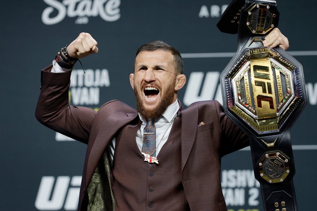 UFC bantamweight champion Merab Dvalishvili, of Georgia, poses with his title belt during a news conference promoting UFC 323, Thursday, Dec. 4, 2025, in Las Vegas. (Steve Marcus/Las Vegas Sun via AP)