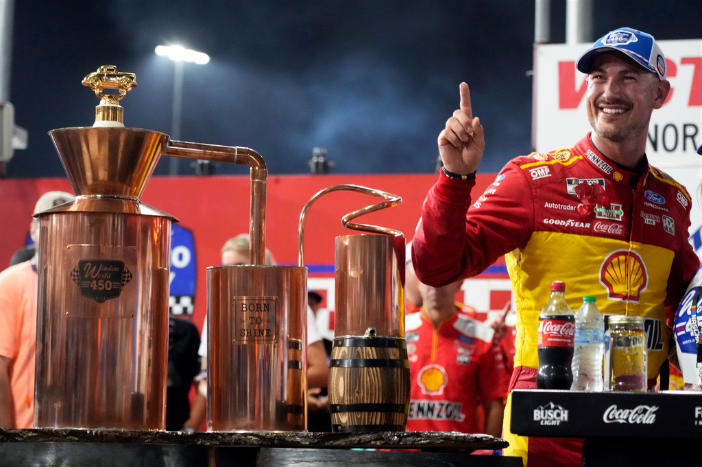 Joey Logano poses with the trophy in Victory Lane after winning a NASCAR Cup Series auto race in North Wilkesboro, N.C., Sunday, July 19, 2026. (AP Photo/Chuck Burton)