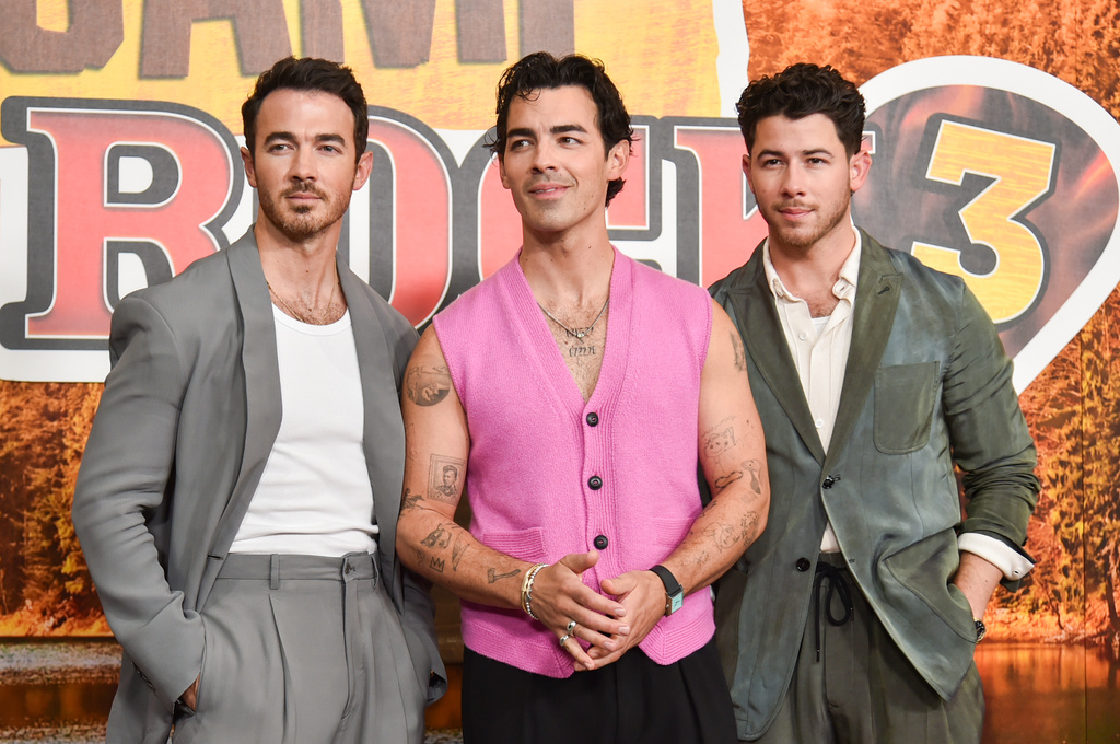 Kevin Jonas, from left, Joe Jonas, and Nick Jonas arrive at the premiere of "Camp Rock 3" on Monday, Aug. 10, 2026, at The Walt Disney Studios in Burbank, Calif. (Photo by Richard Shotwell/Invision/AP)
