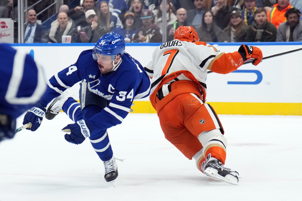 Toronto Maple Leafs Auston Matthews (34) is injured by Anaheim Ducks Radko Gudas (7) during the second period of an NHL hockey game in Toronto, Thursday, March 12, 2026. (Nathan Denette/The Canadian Press via AP)