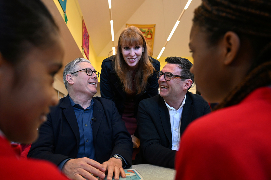 FILE - Britain's Prime Minister Keir Starmer, left, former deputy prime minister Angela Rayner and Manchester Mayor Andy Burnham meet with school children at a primary school in Ashton-under-Lyne, north-west England, Monday April 13, 2026. (Paul Ellis/Pool Photo via AP, File)